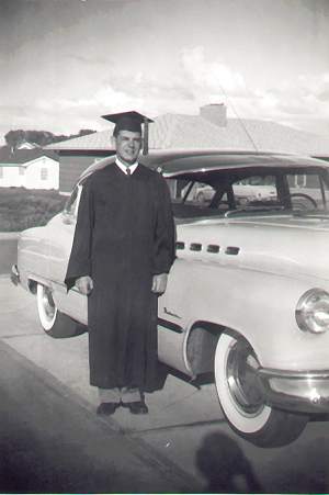 James E. standing by car